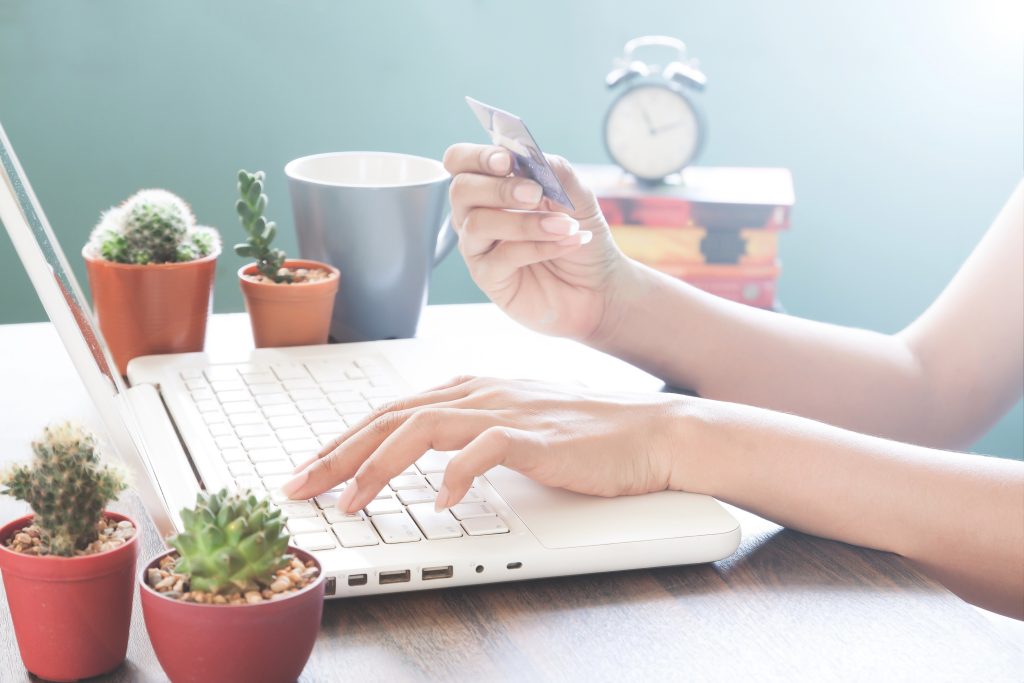 Woman hand using laptop computer and holding credit card, Online